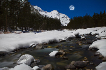 Night view of the mountain river and the blue moon