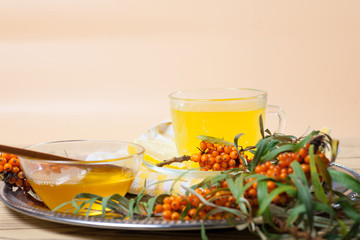 Tea made from sea buckthorn berries healthy for health delicious, saturated with vitamins surrounded by berries and sea buckthorn leaves for family tea drinking and maintaining health in the body