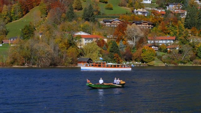 Rowing boat  and excursion boat at lake Tegernsee