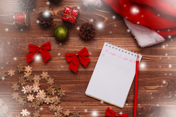 Christmas and New Year background with notepad, pen and decorations. To do list or list of promises, place for your text. Mock up.