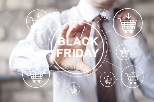 Businessman pressing button black Friday in network shopping cart buy