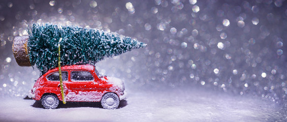 Red Car Carrying A Christmas Tree in The Snowy Night