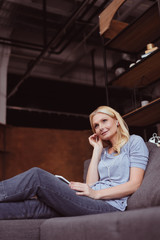 woman in earphones using smartphone