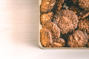 Oat chocolate cookies homemade in metal box on white table