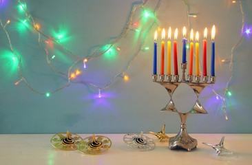 image of jewish holiday Hanukkah background with menorah (traditional candelabra) and burning candles