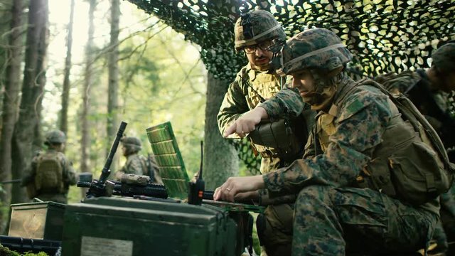 Military Staging Base, Chief Engineer Uses Radio and Army Grade Laptop. Forest Operation/ Mission in Progress.