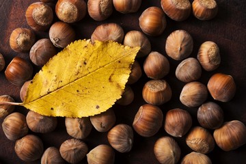 hazelnuts and walnuts with orange autumn leaf decor