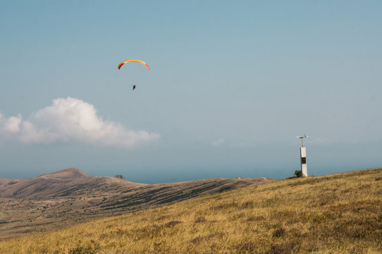 person flying on paraplane