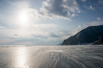 frozen sea and mountains with backlit