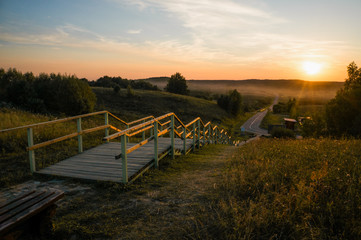 Fototapeta na wymiar wooden stairs at sunset