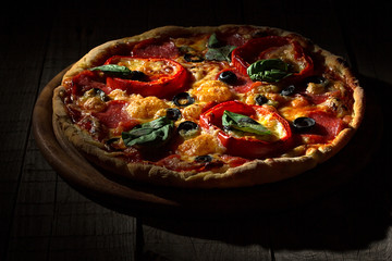 Delicious pizza served on wooden plate