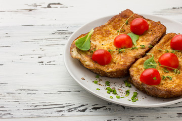 toasted slices of bread baguette with vegetables