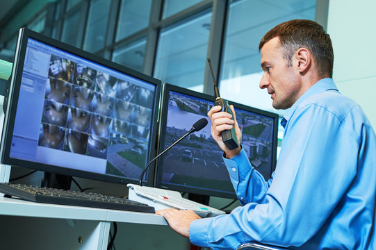 Security worker during monitoring. Video surveillance system.