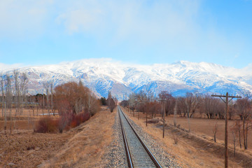 Fototapeta premium Deep Winter Train Tracks and Mountains