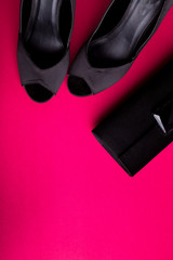 Fashion Lady Accessories Set. Black and pink. Minimal. Black Shoes and bag on pink background. Flat lay.