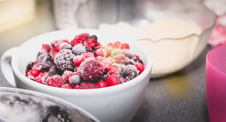 bowl of frozen red fruit on a worktop