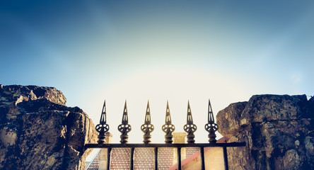 wrought iron fence in the back light