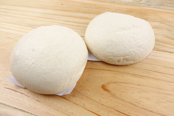 Chinese buns or pau isolated on wooden table.