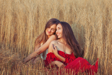Women love to flirt, they are in the field among the tall grass.