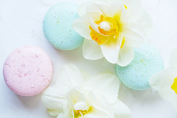 Macaron with spring flowers on white background. Flat lay