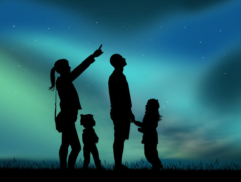 family looking aurora boralis