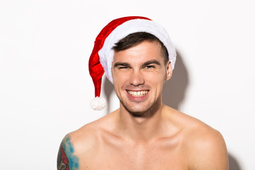 Portrait of a beautiful sexy Santa Claus with tattoo isolated on white background