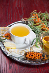 Tea made from sea buckthorn berries healthy for health delicious, saturated with vitamins surrounded by berries and sea buckthorn leaves for family tea drinking and maintaining health in the body