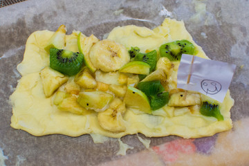 children prepare fruit pizza