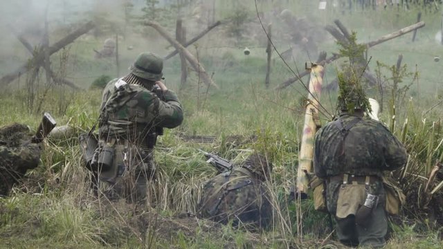 Historical reconstruction of Second World War. Soldiers on battle field during assault on Fort 5 in Koenigsberg. hostilities of Second World war. Slow Motion.