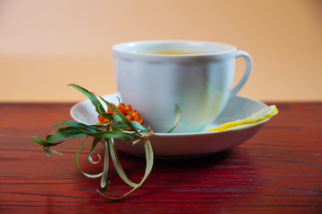Tea made from sea buckthorn berries healthy for health delicious, saturated with vitamins surrounded by berries and sea buckthorn leaves for family tea drinking and maintaining health in the body