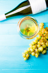 Image from above of glass with juice, grapes, bottle