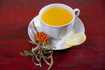 Tea made from sea buckthorn berries healthy for health delicious, saturated with vitamins surrounded by berries and sea buckthorn leaves for family tea drinking and maintaining health in the body