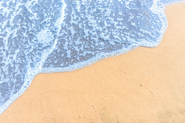Fototapeta na wymiar Soft wave with blue ocean on sandy beach.