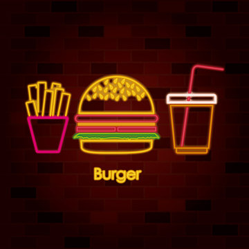 French Fries Burger And Drink On Neon Sign On Brick Wall