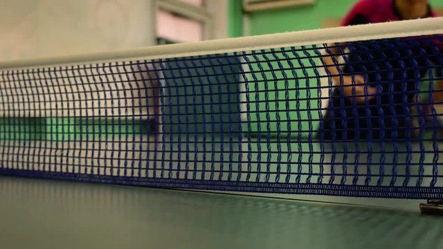 Male playing a game of ping pong. The process of filing the ball ping pong.