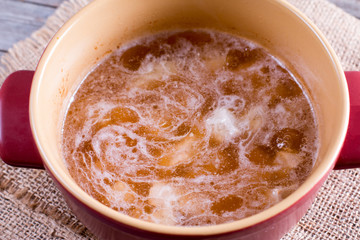 Meat and broth in a saucepan