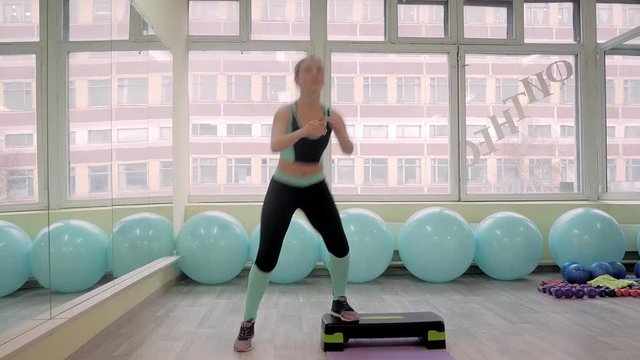 Young woman doing fitness indoors, doing stretching. girl shakes press. healthy lifestyle and sports. camera moves