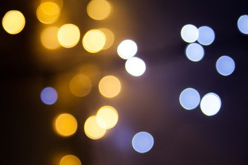 Defocused and scattered in various distances bright bokeh led Christmas wire lights trendy overlay in light blue and yellow color