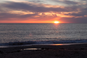 sunset in calm weather on the beach