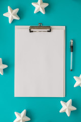 Christmas and New Year holiday to do list with notepad, pen, stars on the blue background. Mock up....