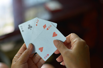 2 heart 2 club and 2 diamond poker cards.