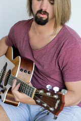 Young man playing acoustic guitar