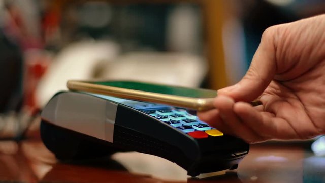 Man using smartphone to pay