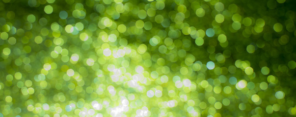 glitter vintage lights background. green and black. de-focused.