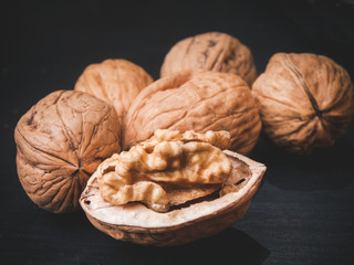 varios walnuts on the table, one is open