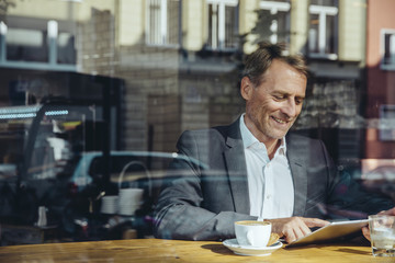 Businessman using tablet in cafe