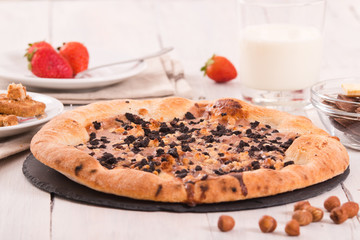 Sweet chocolate pizza with cookies.