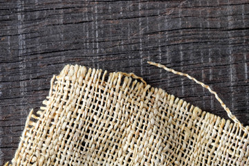 Wood table with old sackcloth burlap tablecloth texture
