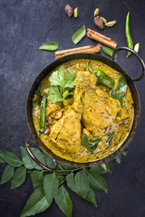 Traditional Indian curry chicken as close-up in a Korai
