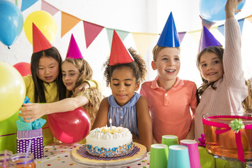 Group of adorable kids having fun at birthday party